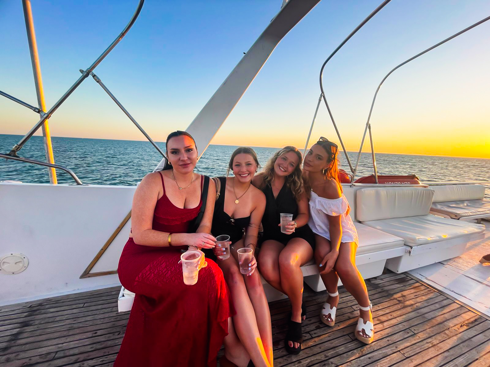 Friends celebrating aboard Sea Señor at golden hour