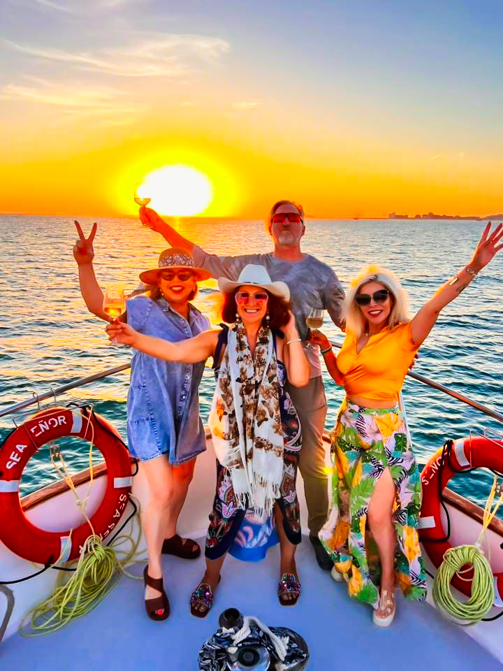 Guests celebrating at sunset aboard Sea Señor